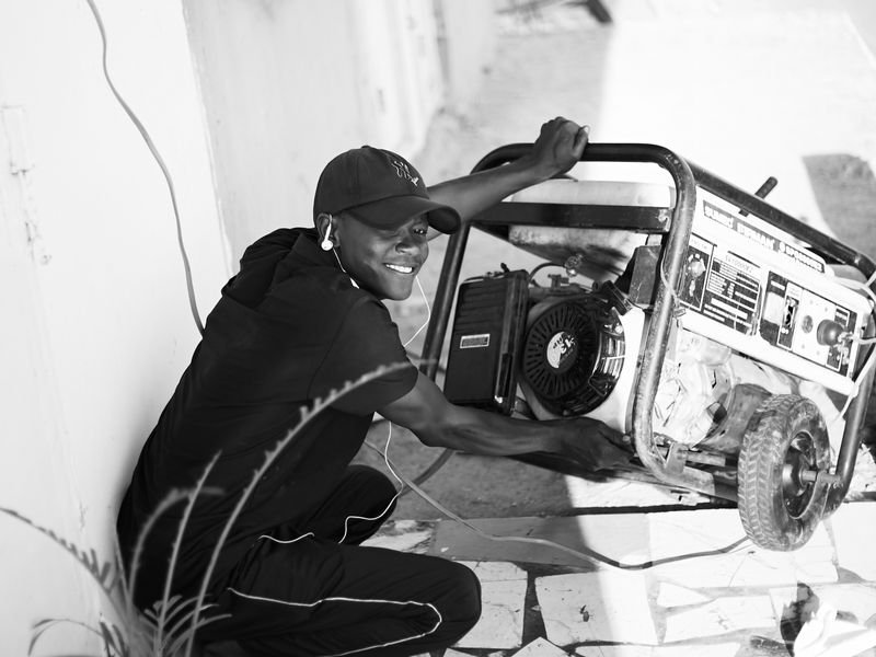Man operating a portable generator outdoors