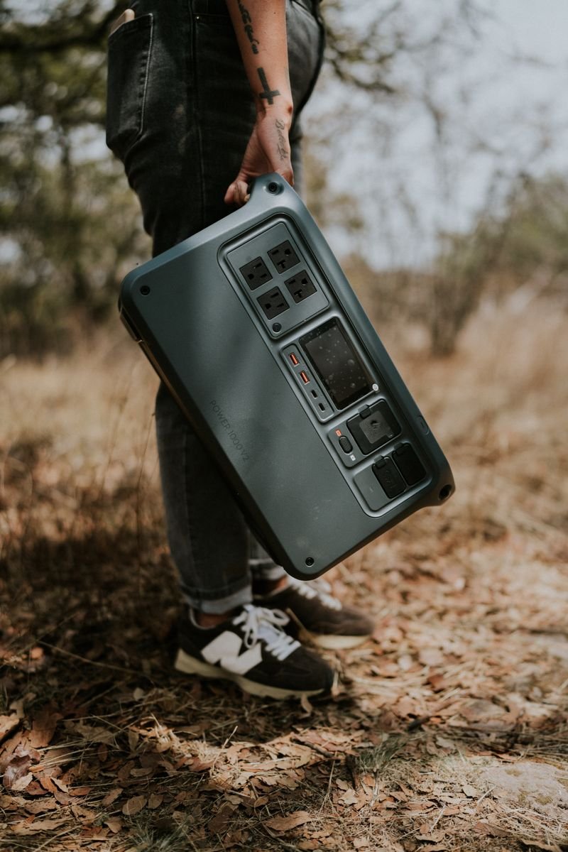 Person carrying a portable power station outdoors